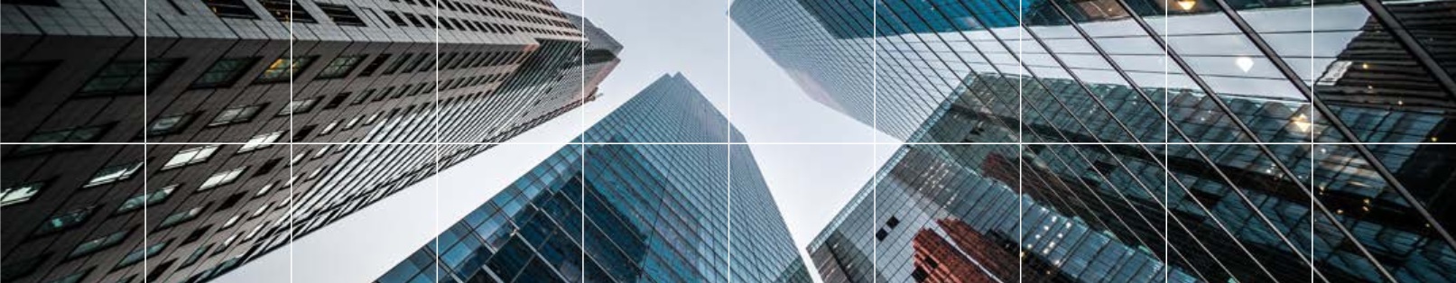 Looking up at modern skyscrapers at dusk